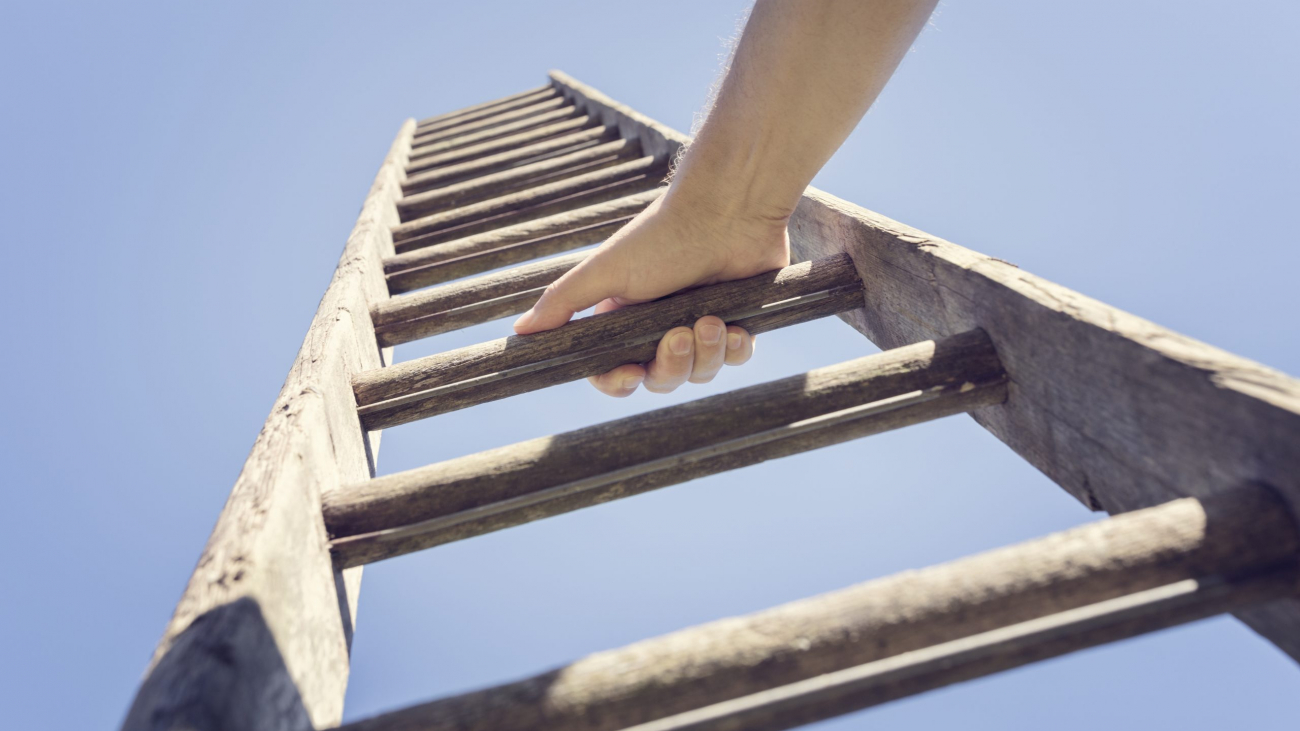 Businessman climbing the corporate ladder of success